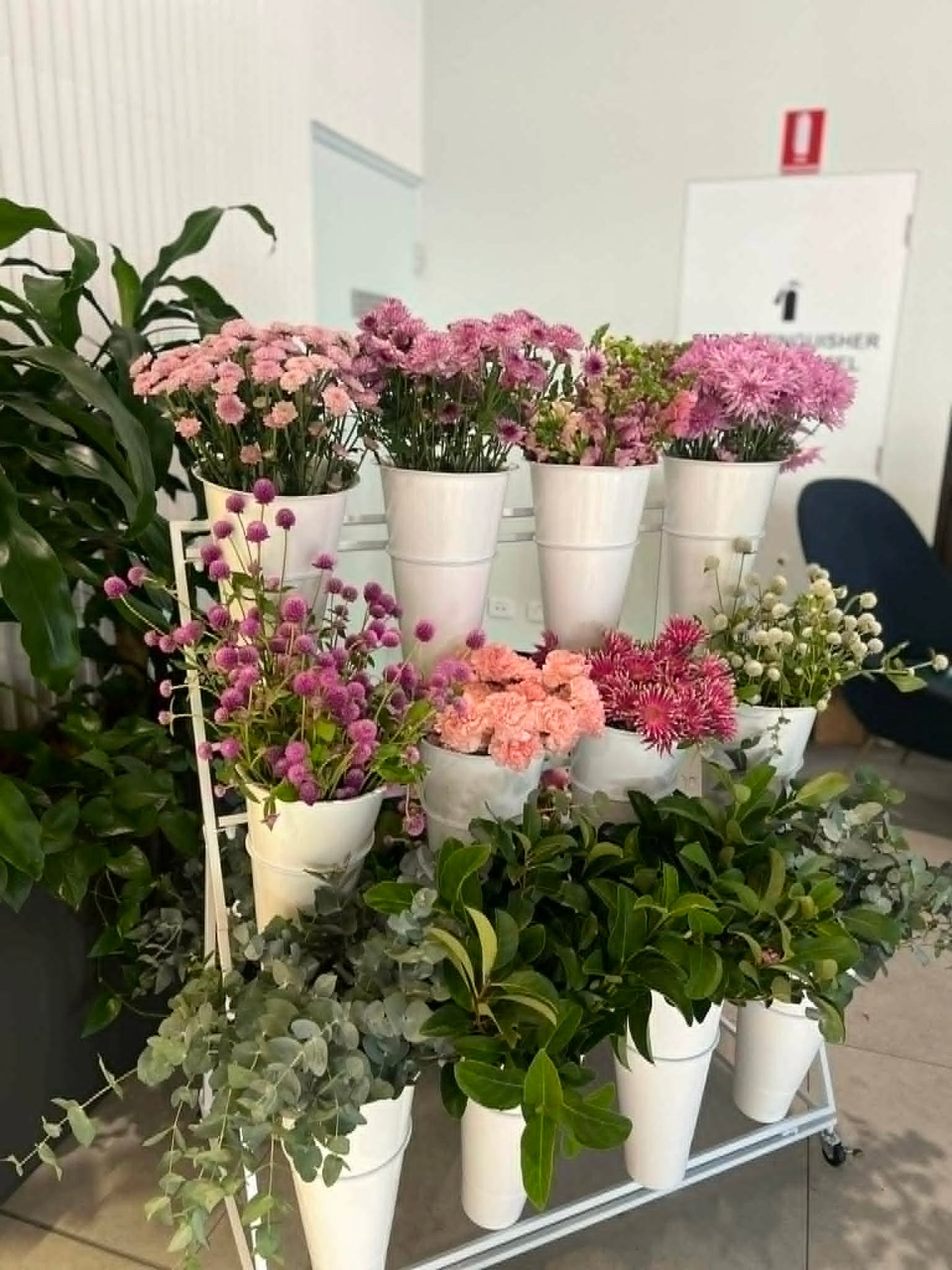 white buckets filled with flowers