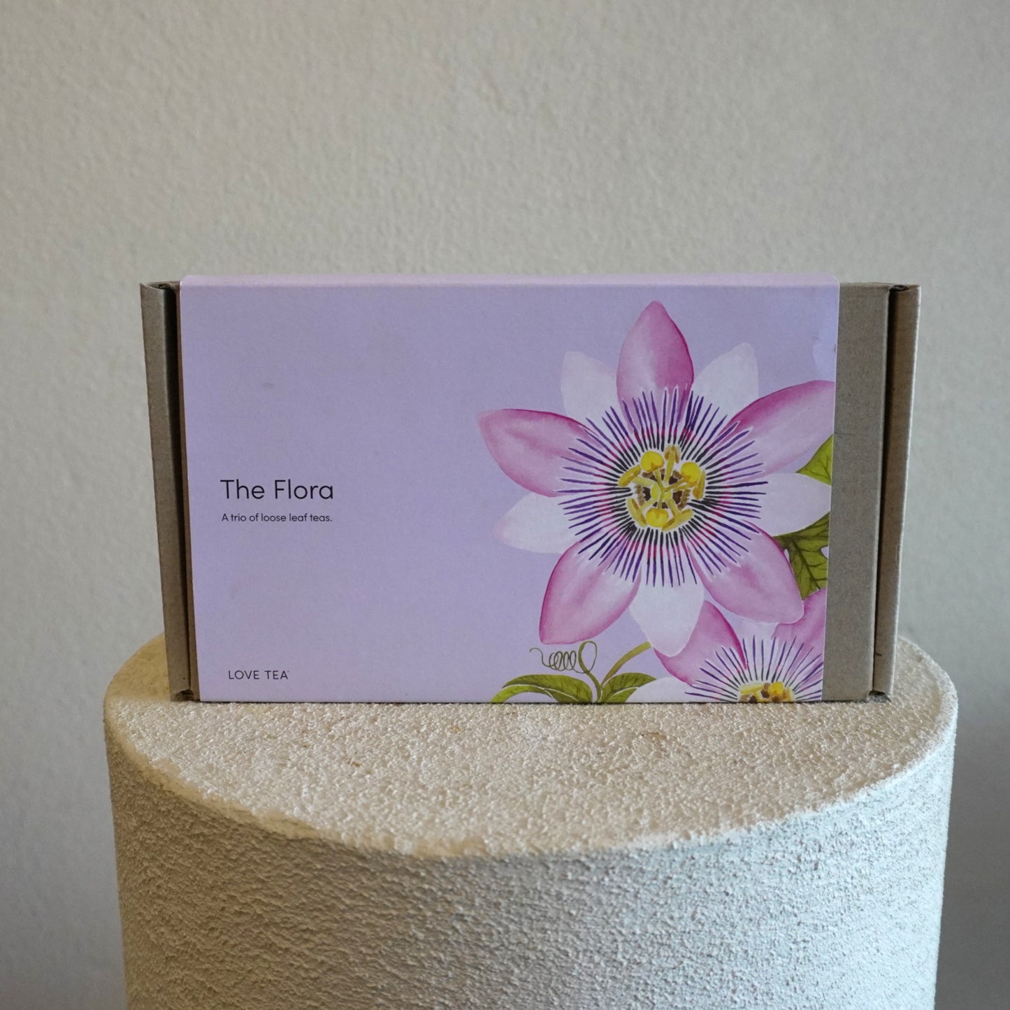 Box labeled 'The Flora' with a pink flower design on a white surface.