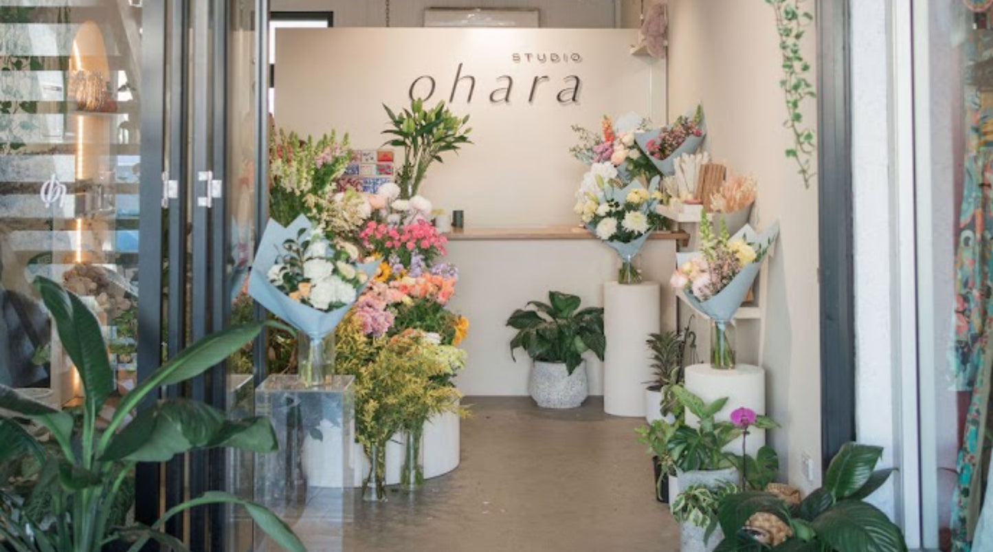 Floral studio with 'Studio Ohara' sign and various flower arrangements.